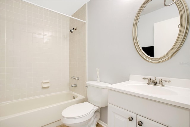 full bathroom with vanity, tiled shower / bath combo, and toilet