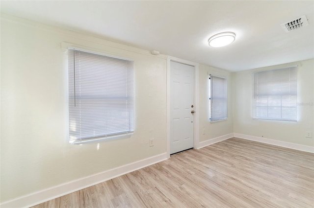 entryway featuring light wood-type flooring, visible vents, and baseboards