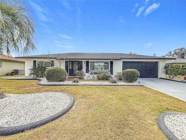 ranch-style house featuring cooling unit, a garage, and a front yard