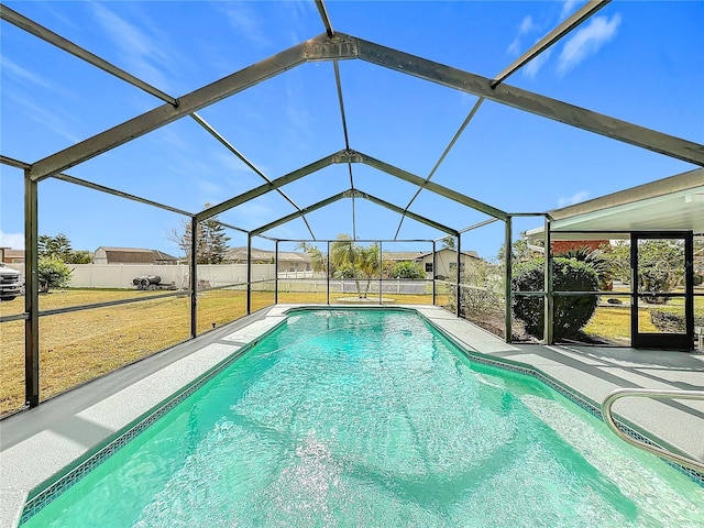 view of pool featuring a lanai, a lawn, and a patio area