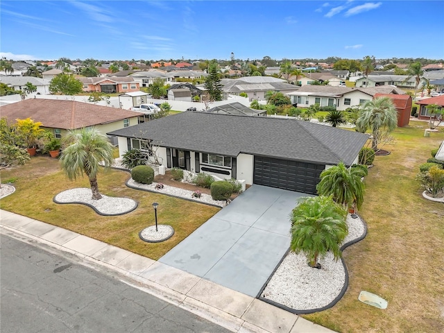 ranch-style home featuring a garage and a front yard