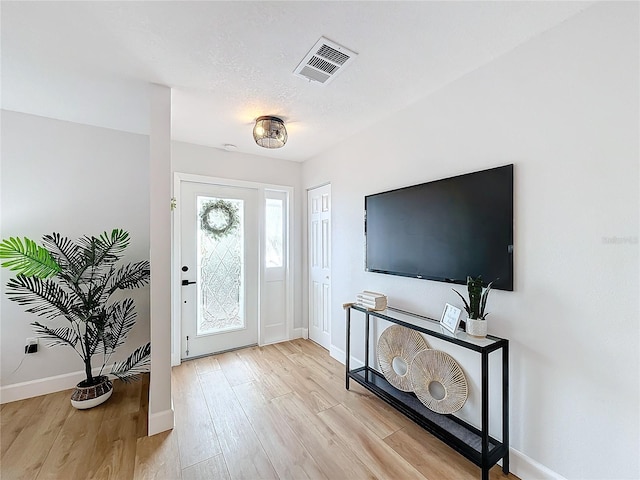 entryway with light hardwood / wood-style flooring