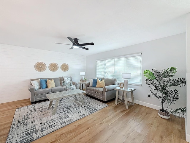 living room featuring ceiling fan and light hardwood / wood-style floors