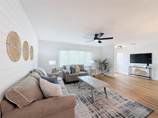 living room with hardwood / wood-style floors and ceiling fan