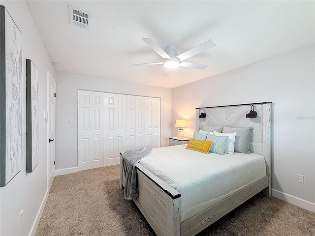 carpeted bedroom with a closet and ceiling fan