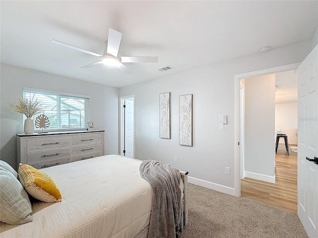 bedroom with ceiling fan and light carpet