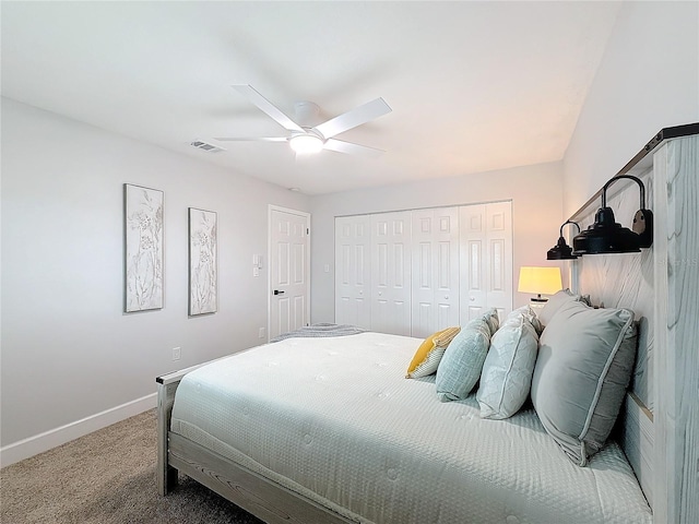 bedroom with ceiling fan, carpet floors, and a closet