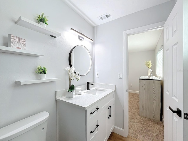 bathroom with vanity and toilet