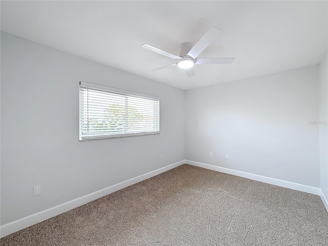 carpeted spare room with ceiling fan