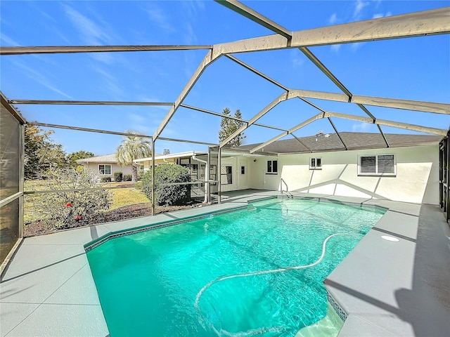 view of swimming pool with a patio and glass enclosure