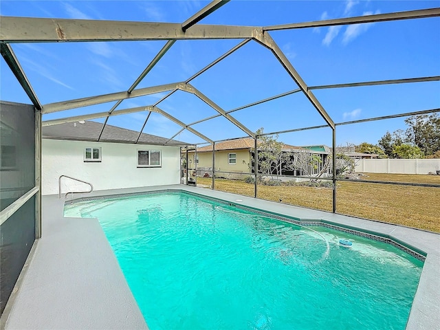 view of swimming pool with a yard and glass enclosure