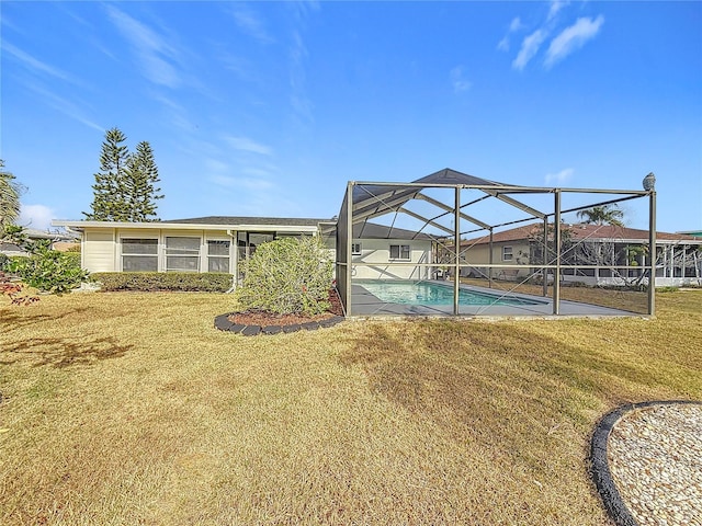 back of property with a lawn and a lanai