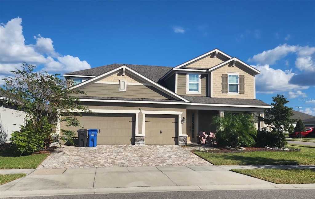 craftsman-style house with a garage and a front yard