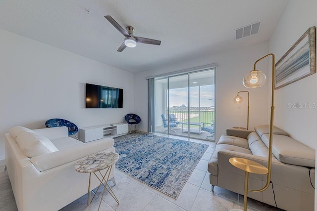 tiled living room featuring ceiling fan