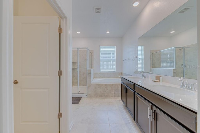 bathroom with tile patterned floors, vanity, and separate shower and tub