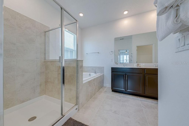 bathroom with tile patterned flooring, vanity, and separate shower and tub