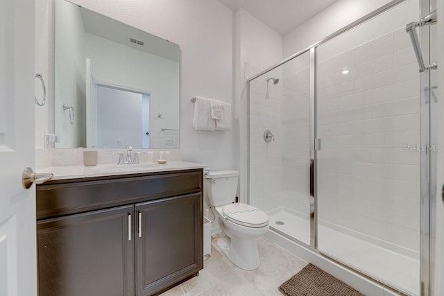 bathroom with a shower with door, vanity, and toilet