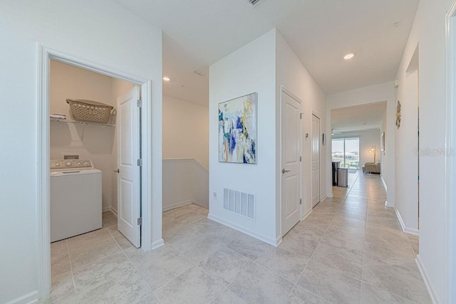 hallway with washer / dryer