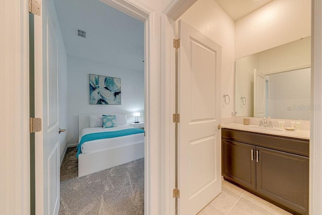 bathroom with tile patterned flooring and vanity