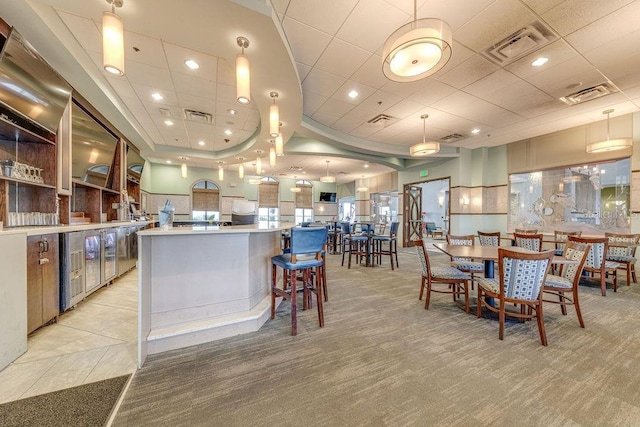 kitchen featuring light carpet, pendant lighting, and a spacious island