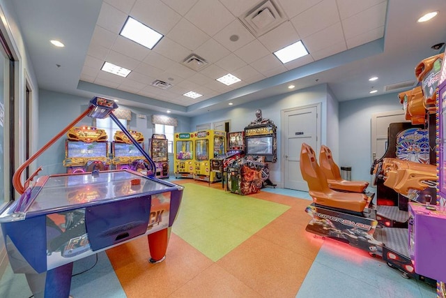 playroom featuring a raised ceiling and a paneled ceiling