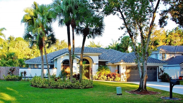 view of front facade with a garage and a front lawn