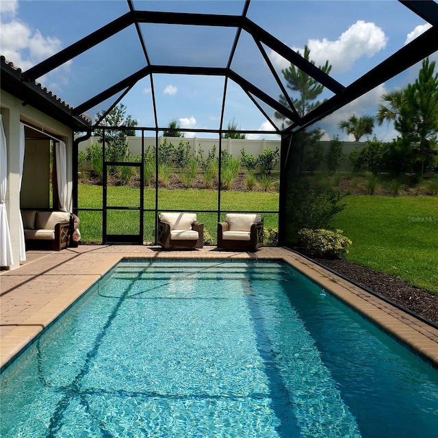 view of swimming pool featuring glass enclosure, a yard, and a patio