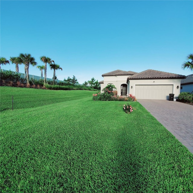 view of front of property with a garage and a front yard