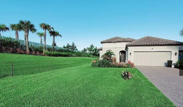 view of front of property featuring a garage and a front yard