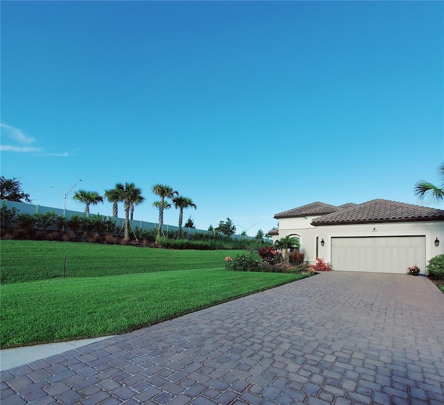 view of front of house with a garage and a front yard