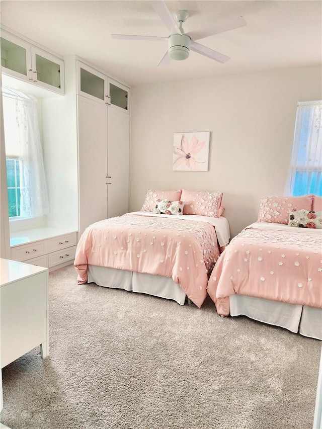 carpeted bedroom featuring a closet and ceiling fan