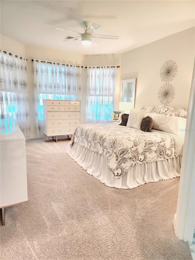 bedroom featuring ceiling fan and carpet