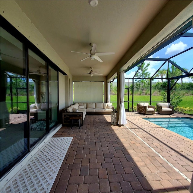 view of patio / terrace with a lanai, an outdoor hangout area, and ceiling fan