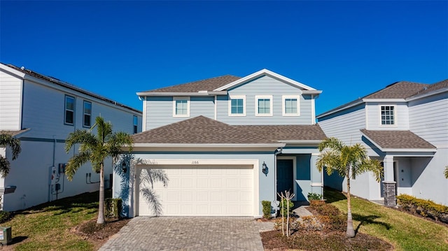 1166 Aloha Blvd, Davenport, FL 33897 - view of front of house featuring decorative driveway and roof with shingles