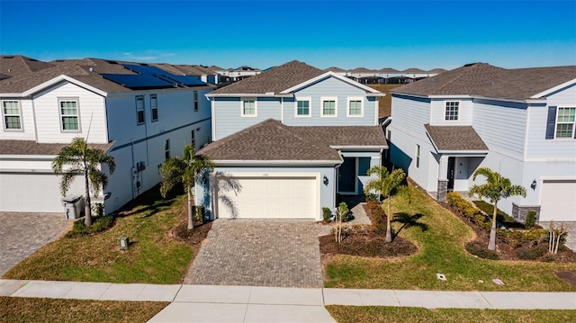 1166 Aloha Blvd, Davenport, FL 33897 - traditional-style home featuring a residential view, decorative driveway, a shingled roof, and a front lawn