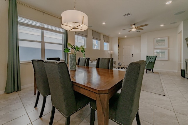 dining room featuring ceiling fan with notable chandelier and light tile patterned floors