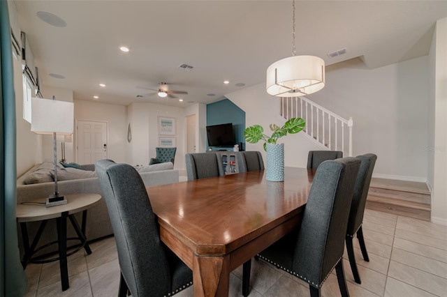 dining space featuring light tile patterned floors and ceiling fan