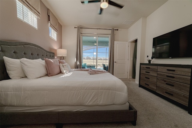 carpeted bedroom featuring ceiling fan and access to outside