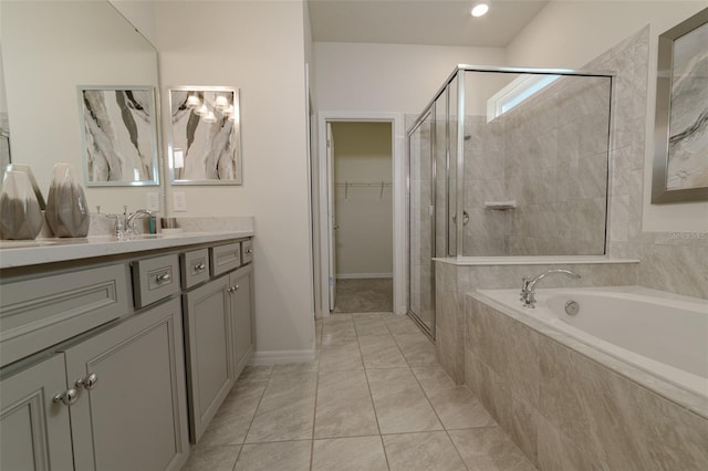 bathroom with tile patterned floors, vanity, and independent shower and bath