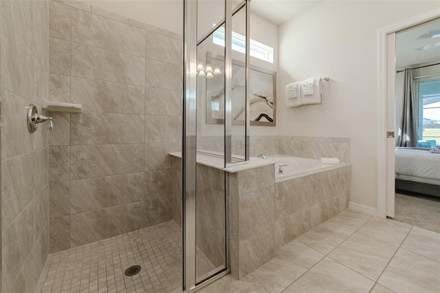 bathroom with separate shower and tub and tile patterned floors