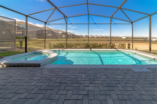 1166 Aloha Blvd, Davenport, FL 33897 - view of swimming pool with a patio area, glass enclosure, and a pool with connected hot tub