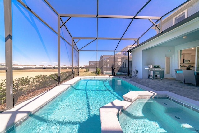 1166 Aloha Blvd, Davenport, FL 33897 - view of pool with area for grilling, a pool with connected hot tub, a patio, and glass enclosure