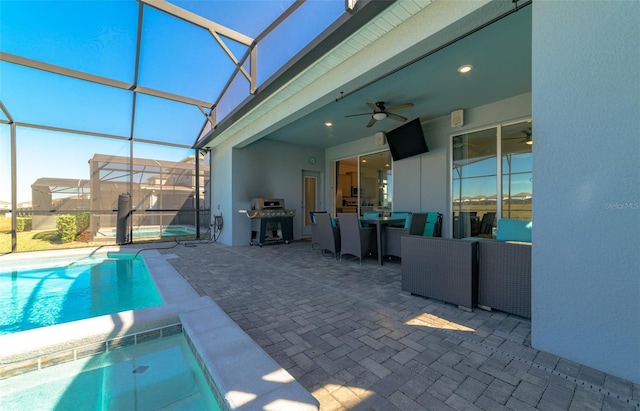 view of swimming pool featuring glass enclosure, ceiling fan, and a patio area