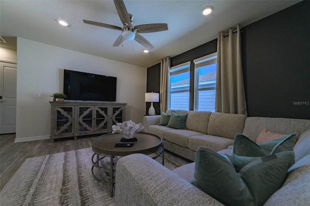 living room with hardwood / wood-style floors and ceiling fan