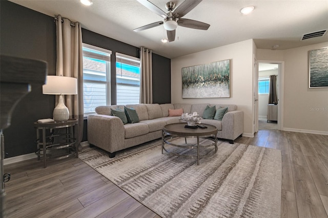 living room with hardwood / wood-style flooring and ceiling fan