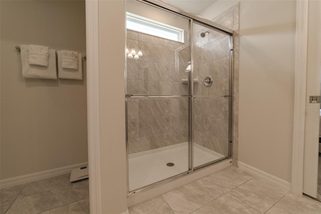 bathroom featuring a shower with door