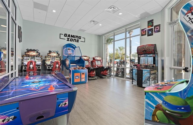 game room featuring a drop ceiling and wood-type flooring