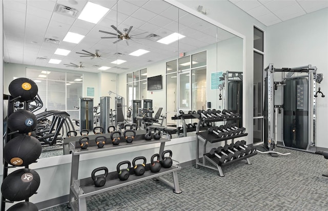 gym with a drop ceiling and ceiling fan