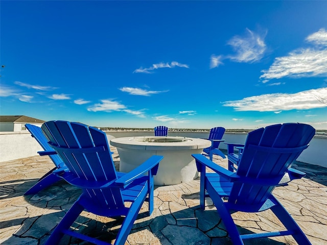 view of patio / terrace featuring a water view and an outdoor fire pit