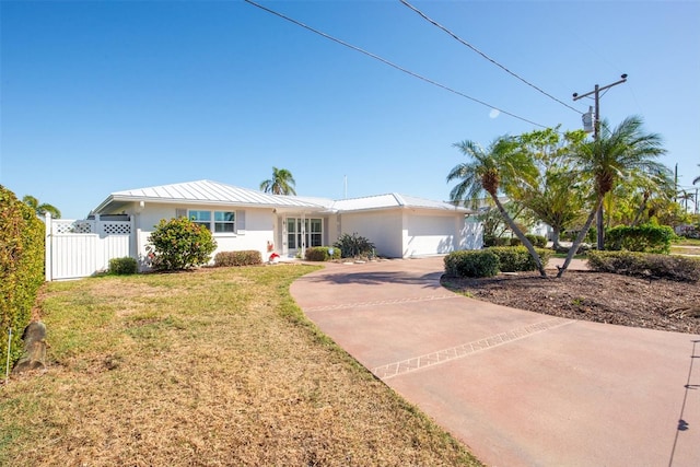 ranch-style home with a front yard and a garage